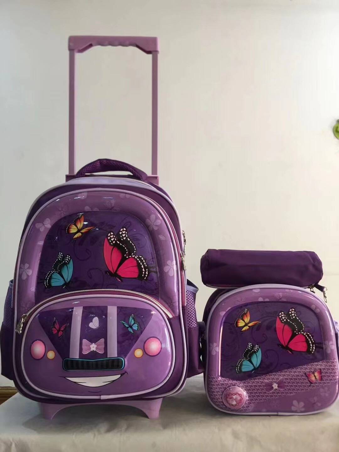 Un conjunto de tres piezas de mochila con barra de tracción, mochila de PU de 16 pulgadas para estudiantes, estuche para lápices, mochila mediana, mochila para niños, poste cuadrado de tres ruedas 