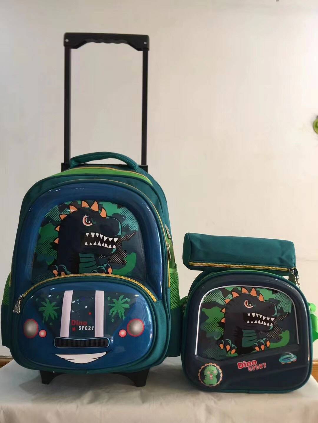 Un conjunto de tres piezas de mochila con barra de tracción, mochila de PU de 16 pulgadas para estudiantes, estuche para lápices, mochila mediana, mochila para niños, poste cuadrado de tres ruedas 