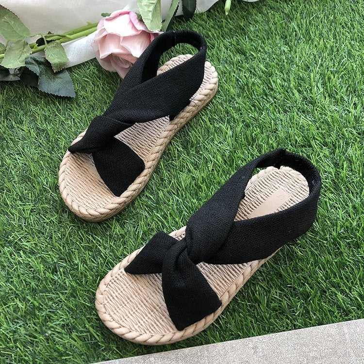 Sandalias nuevas de verano 2024 para mujer, ropa de calle, sandalias romanas de lino tejido con césped, correas elásticas, suela plana cruzada, zapatos de mujer al por mayor 