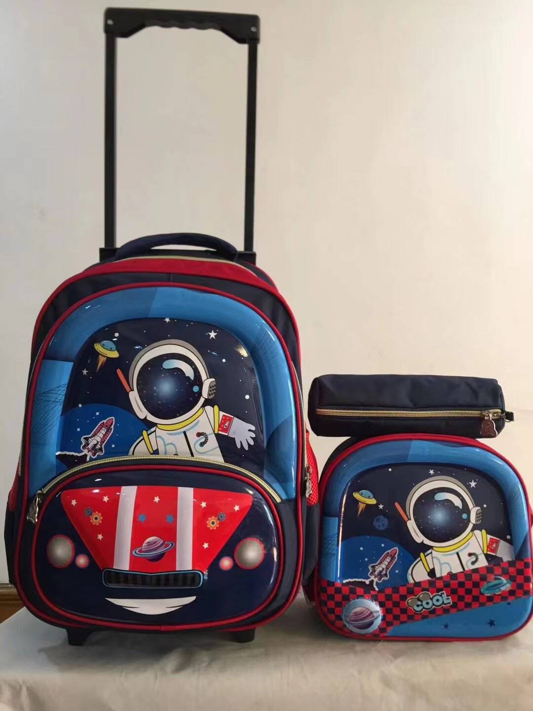 A three piece set of pull rod backpack, student 16 inch PU backpack, pencil case, medium backpack, children's backpack, three wheel square pole