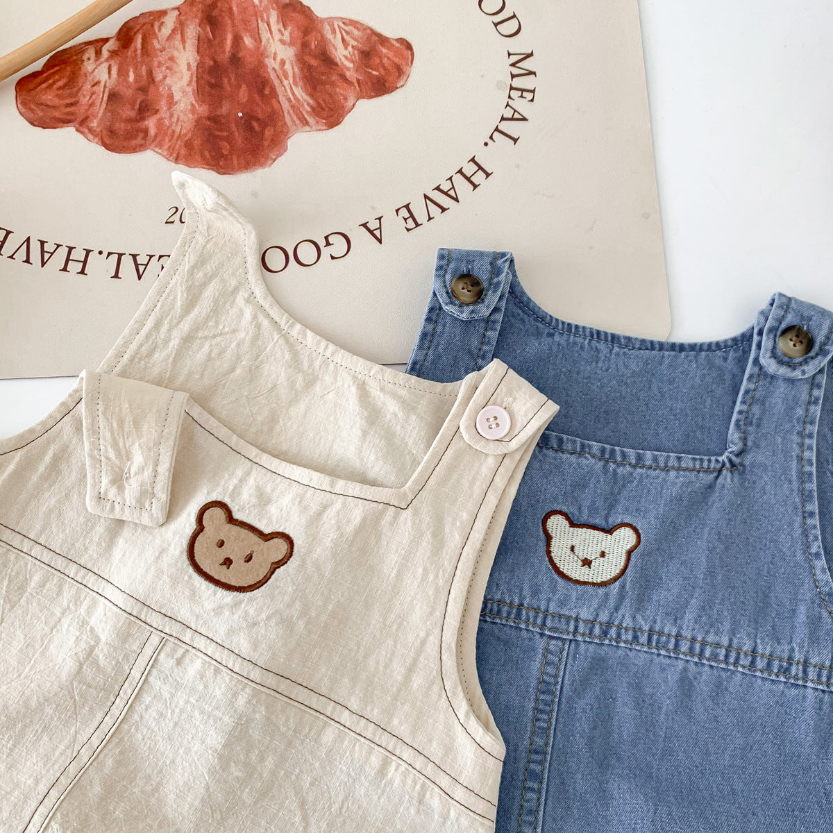 A South Korean children's clothing summer cartoon teddy bear bag fart jacket ins baby shoulder strap triangle jumpsuit