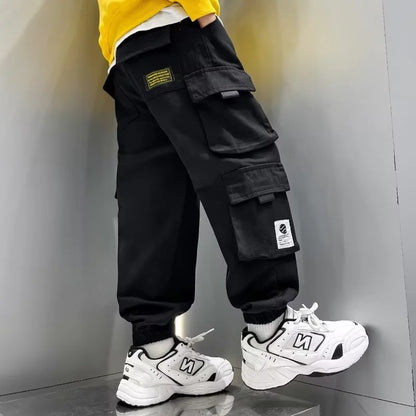 A boys pants spring and autumn 2024 children's overalls spring and autumn middle-aged older boys ruffian handsome gas tied feet trousers tide