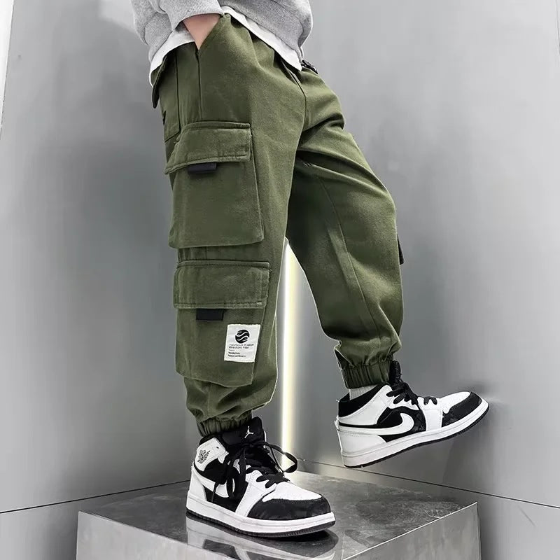 A boys pants spring and autumn 2024 children's overalls spring and autumn middle-aged older boys ruffian handsome gas tied feet trousers tide